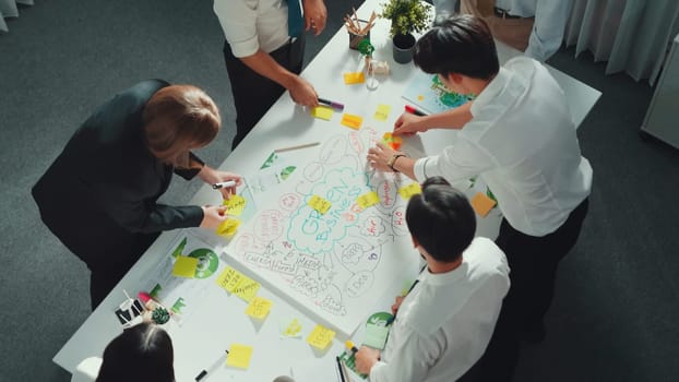 Top view of professional business team working together to brainstorm environmental idea by using mind map. Aerial view of smart manager talking and discussing about sustainable energy. Alimentation.