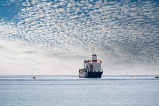 Oil chemical tanker anchored in the Mediterranean sea on a cloudy day