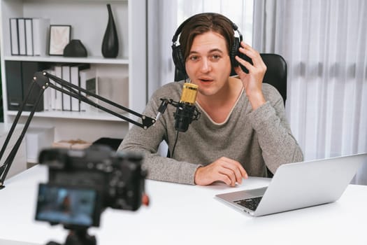 Host channel in smart broadcaster recording by camera with talking show on live social media, broadcasting on social media, wearing headphones to record video streamer at modern studio. Pecuniary.