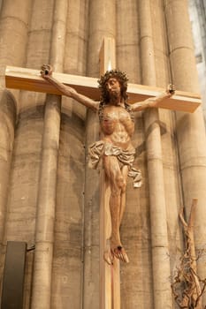 A statue of Jesus hanging on a cross in a church