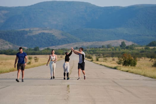 A group of friends maintains a healthy lifestyle by running outdoors on a sunny day, bonding over fitness and enjoying the energizing effects of exercise and nature.