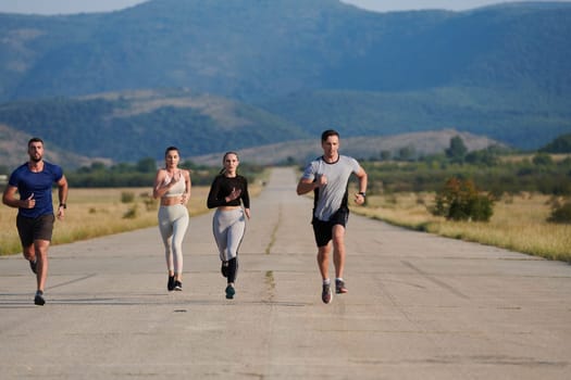 A group of friends maintains a healthy lifestyle by running outdoors on a sunny day, bonding over fitness and enjoying the energizing effects of exercise and nature.