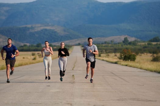 A group of friends maintains a healthy lifestyle by running outdoors on a sunny day, bonding over fitness and enjoying the energizing effects of exercise and nature.