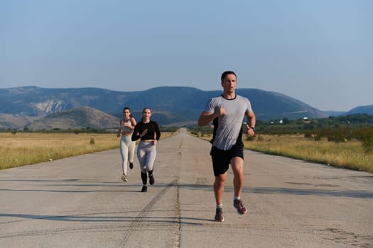 A group of friends maintains a healthy lifestyle by running outdoors on a sunny day, bonding over fitness and enjoying the energizing effects of exercise and nature.