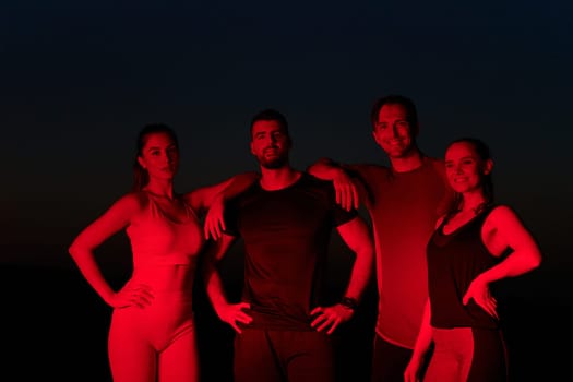 In the late-night hours, a diverse group of exhausted athletes find solace under a red glow, reflecting on their day-long marathon journey and celebrating camaraderie amidst fatigue.