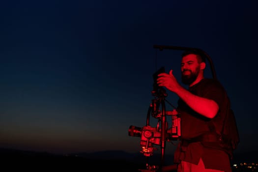 A skilled videographer captures the intensity of athletes running, illuminated by vibrant red lights, encapsulating the energy and determination of their nighttime training session.