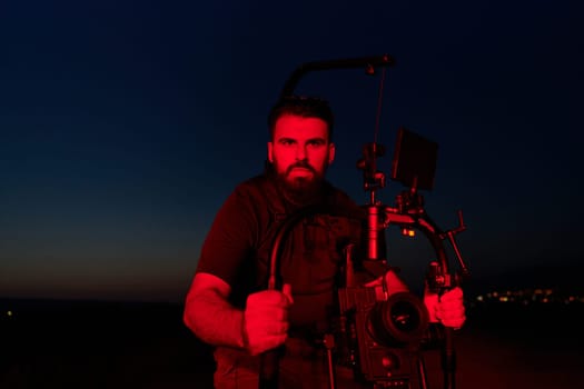 A skilled videographer captures the intensity of athletes running, illuminated by vibrant red lights, encapsulating the energy and determination of their nighttime training session.