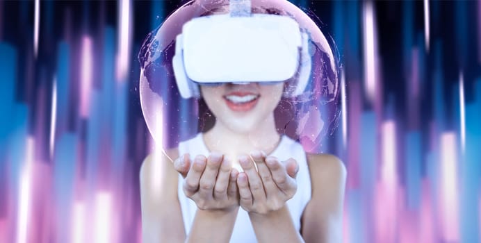 Female stand and wear white VR headset and white sleeveless connect metaverse, future technology, surronded by abstract light. community. She hold and see 3d hologram of global picture. Hallucination.