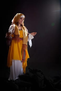 A girl or young woman from ancient Israel, Palestine, Iran, Iraq with a clay jug. A biblical story with Rebekah and water. Stylized photo shoot with a model in Middle Eastern clothes