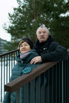 Cute mature couple went for a walk in the cold season of winter.