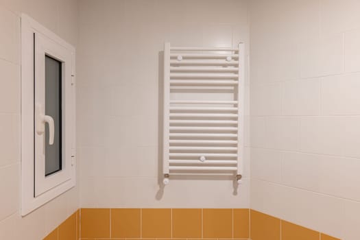 A modern bathroom with orange tiles and white fixtures