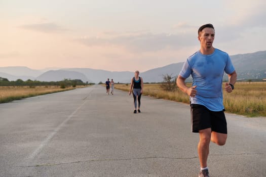 A group of friends maintains a healthy lifestyle by running outdoors on a sunny day, bonding over fitness and enjoying the energizing effects of exercise and nature.