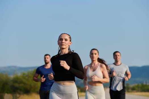 A group of friends maintains a healthy lifestyle by running outdoors on a sunny day, bonding over fitness and enjoying the energizing effects of exercise and nature.