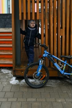 Child boy likes to spend time riding a bike.