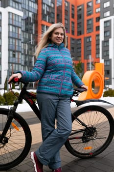Athletic woman enjoys traveling around the city using a bicycle.