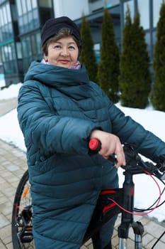 An elderly woman went for a bike ride in the cold.