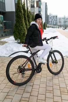 Young woman went out for a bike ride in winter.