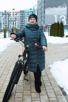 Mature European woman extends longevity and rides a bicycle.