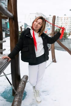 European woman in winter clothes spends time walking outdoors.