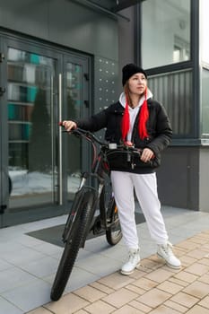 Young woman went out for a bike ride in winter.