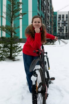 Active European woman in a red jacket rented a bicycle.