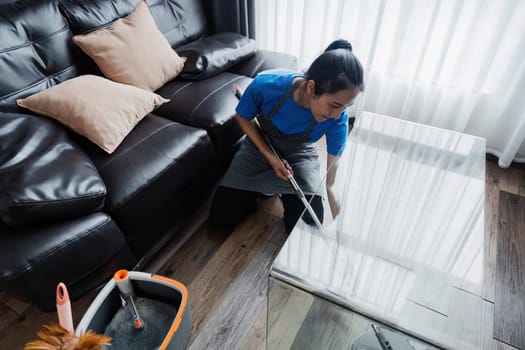 cleaning service housekeeper women swipe floor in living room. House cleaning service concept.