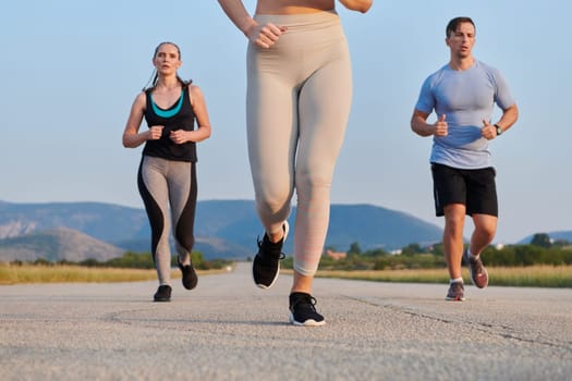 A group of friends maintains a healthy lifestyle by running outdoors on a sunny day, bonding over fitness and enjoying the energizing effects of exercise and nature.