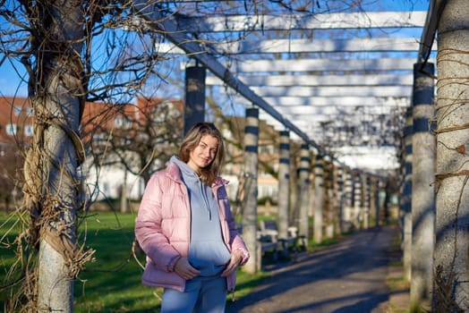 Winter Fun in Bitigheim-Bissingen: Beautiful Girl in Pink Jacket Amidst Half-Timbered Charm. Step into the festive winter spirit with this captivating image of a lovely girl in a pink winter jacket standing in the archway of the historic town of Bitigheim-Bissingen, Baden-Württemberg, Germany. The backdrop features charming half-timbered houses, enhanced by warm vintage photo processing, creating a delightful scene of winter joy and architectural beauty.