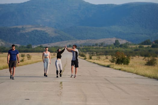 A group of friends maintains a healthy lifestyle by running outdoors on a sunny day, bonding over fitness and enjoying the energizing effects of exercise and nature.