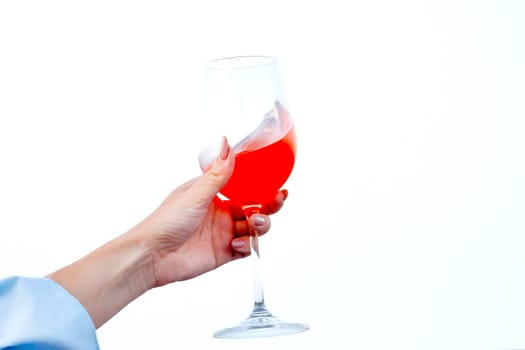 hand of a girl with wine in her hands on a white background, rest