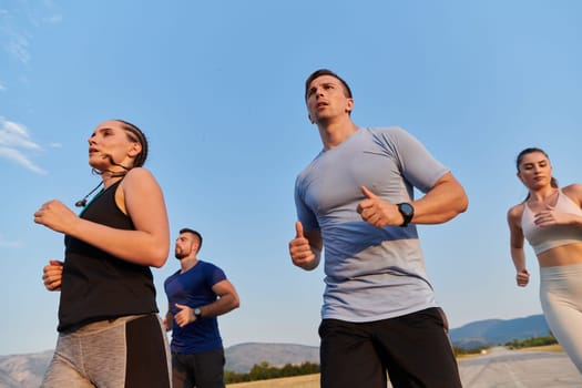 A group of friends maintains a healthy lifestyle by running outdoors on a sunny day, bonding over fitness and enjoying the energizing effects of exercise and nature.