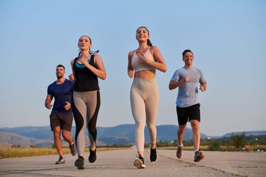 A group of friends maintains a healthy lifestyle by running outdoors on a sunny day, bonding over fitness and enjoying the energizing effects of exercise and nature.