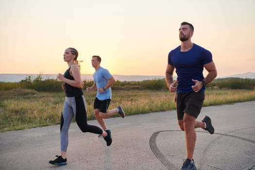 A diverse group of runners finds motivation and inspiration in each other as they train together for an upcoming competition, set against a breathtaking sunset backdrop.