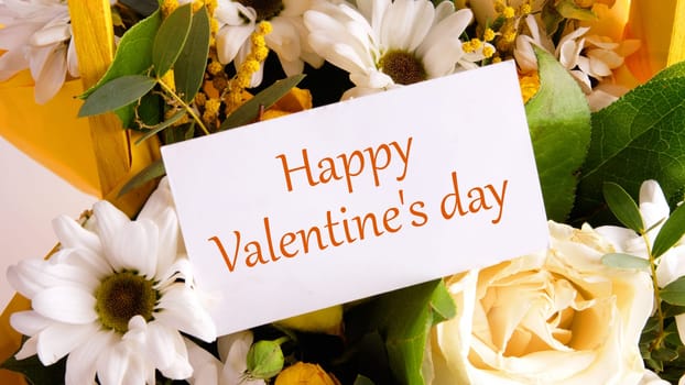 Happy Valentine's day text on a business card on a background of flowers