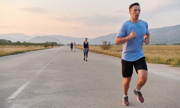 A group of friends maintains a healthy lifestyle by running outdoors on a sunny day, bonding over fitness and enjoying the energizing effects of exercise and nature.