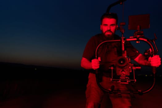 A skilled videographer captures the intensity of athletes running, illuminated by vibrant red lights, encapsulating the energy and determination of their nighttime training session.