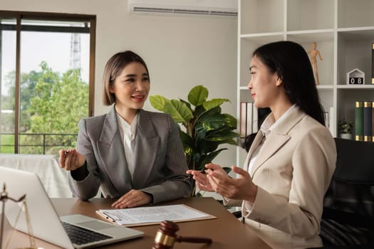 A lawyer and a businesswoman are discussing legal advice on signing a business contract. Signing an insurance or financial contract.