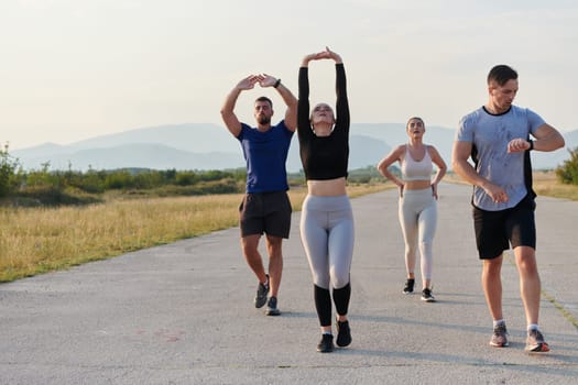 A group of friends maintains a healthy lifestyle by running outdoors on a sunny day, bonding over fitness and enjoying the energizing effects of exercise and nature.