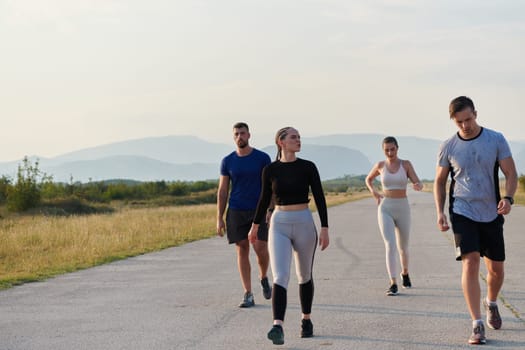 A group of friends maintains a healthy lifestyle by running outdoors on a sunny day, bonding over fitness and enjoying the energizing effects of exercise and nature.