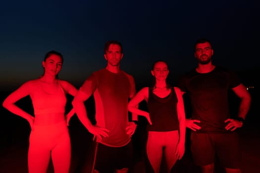 In the late-night hours, a diverse group of exhausted athletes find solace under a red glow, reflecting on their day-long marathon journey and celebrating camaraderie amidst fatigue.