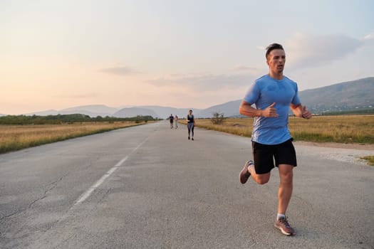 A group of friends maintains a healthy lifestyle by running outdoors on a sunny day, bonding over fitness and enjoying the energizing effects of exercise and nature.