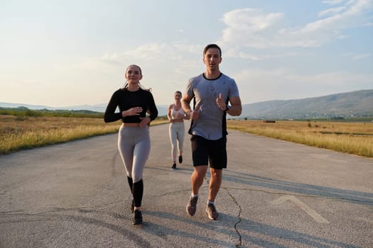 A group of friends maintains a healthy lifestyle by running outdoors on a sunny day, bonding over fitness and enjoying the energizing effects of exercise and nature.