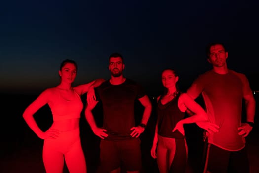 In the late-night hours, a diverse group of exhausted athletes find solace under a red glow, reflecting on their day-long marathon journey and celebrating camaraderie amidst fatigue.