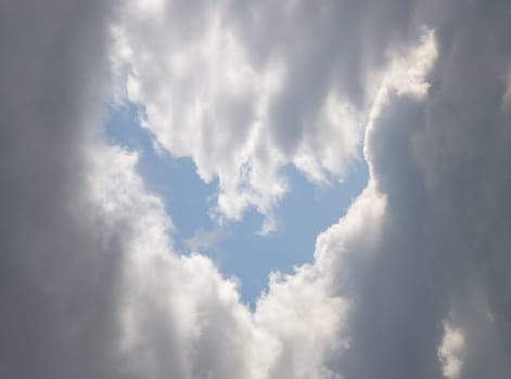 The sun's rays passing through the clouds and shining form an interesting light pattern against the sky. Space for text, Selective focus.