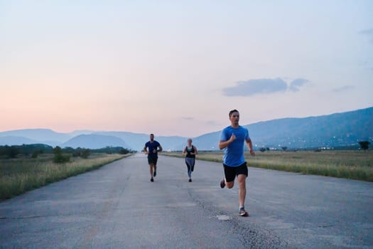 A diverse group of runners finds motivation and inspiration in each other as they train together for an upcoming competition, set against a breathtaking sunset backdrop.