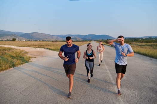 A group of friends maintains a healthy lifestyle by running outdoors on a sunny day, bonding over fitness and enjoying the energizing effects of exercise and nature.