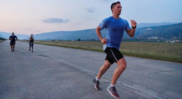 A group of friends maintains a healthy lifestyle by running outdoors on a sunny day, bonding over fitness and enjoying the energizing effects of exercise and nature.