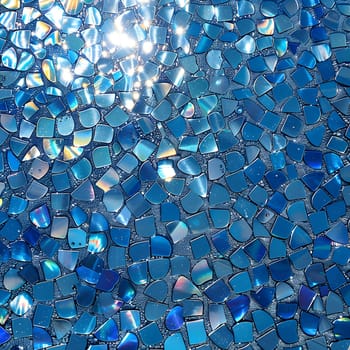 Aqua glass tiles create a fluid and artistic pattern on the floor, reflecting an electric blue hue when the sun shines through, resembling a natural material masterpiece