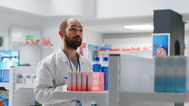 Pharmacist doing inventory using hologram projection, counting boxes of medicaments and supplements. Drugstore employee working on procuring medical supplies, artificial intelligence. Camera 2.