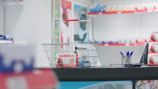 Empty pharmacy checkout counter with boxes of medicine, selling modern pills or pharmaceutical drugs on shelves in drugstore clinic. Medical supplies are for sale along with other treatments.